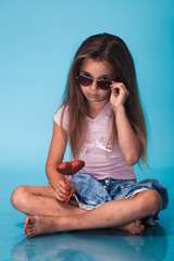 Wall Mural - cute little girl on blue background