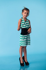 Wall Mural - little girl wearing big mothers shoes