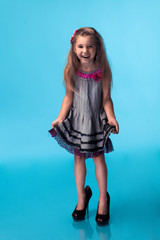 Wall Mural - little girl wearing big mothers shoes