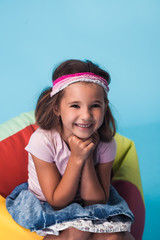 Wall Mural - cute little girl on blue background