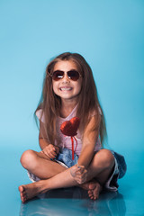 Wall Mural - cute little girl on blue background