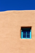 Blue Window On Adobe Wall