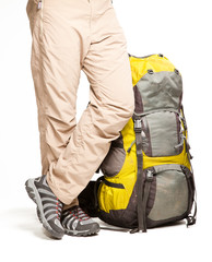  Man stands near packed backpack and ready to go