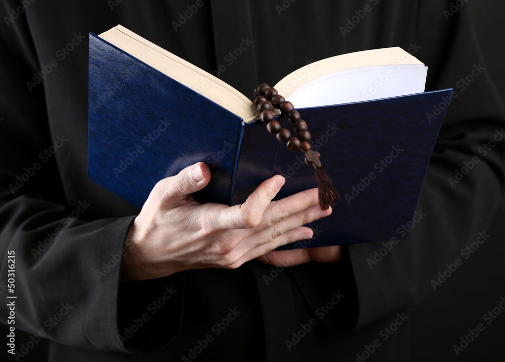 Priest reading from the holy bible, close up