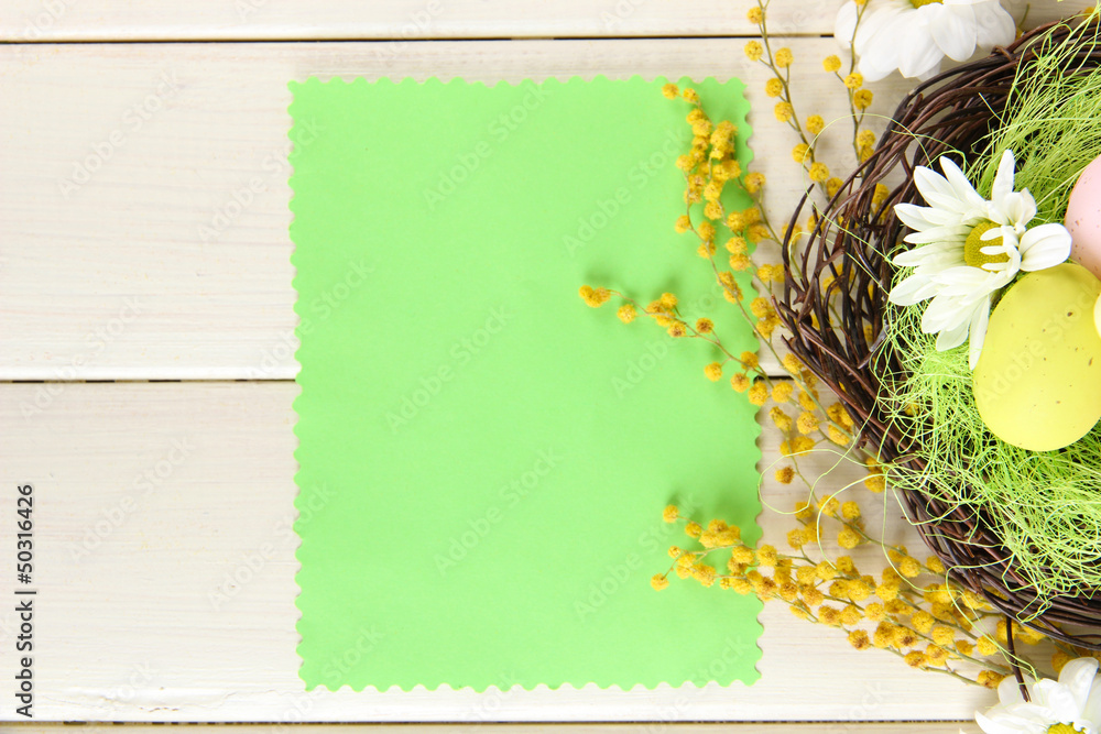 Empty card with easter eggs and mimosa flowers,