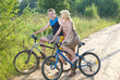 © Konstantin Kulikov - The guy and the girl by bicycles on the rural road