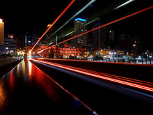Motion Blur Effect Caused By Red Taillights Of Fast Driving Bus Creating Light Trails At Night Brisbane City Center In Australia 