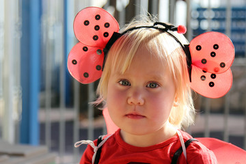 cute 2 years old girl dressed as a ladybug