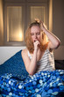 © listercz - young caucasian woman in bed with headache and hangover