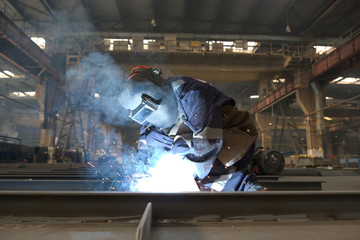 Wall Mural - welder in factory and smoke rising