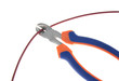 Metal nippers is cutting red cable on white background