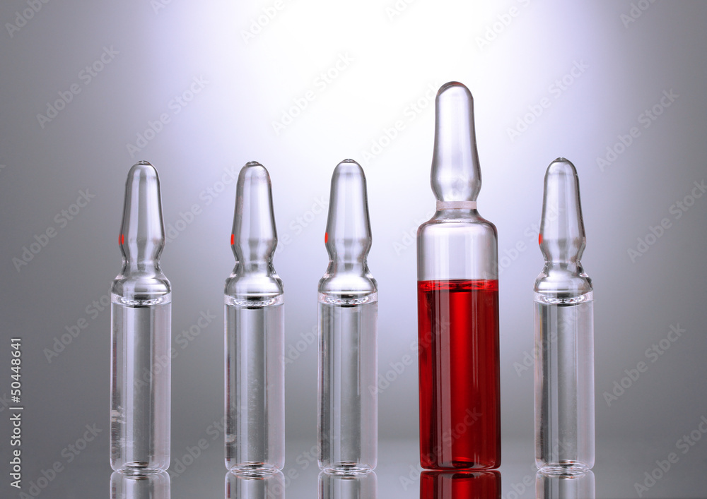 medical ampules on grey background