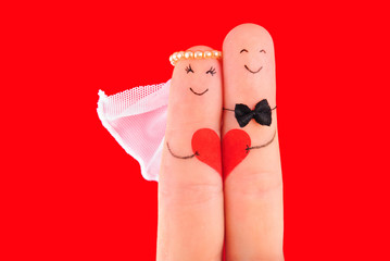 wedding concept, newlyweds with  heart against red background, p