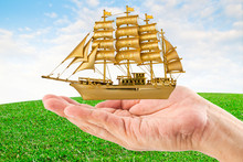 Hands Holding Golden Ship Good Luck With Some Text