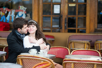 Loving couple in a Parisian cafe