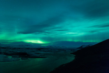 Wall Mural - northern lights above lagoon in iceland