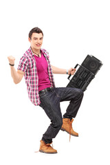 Canvas Print - Full length portrait of a young man holding a radio and gesturin