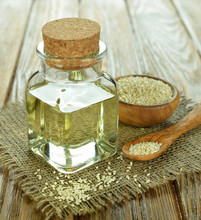 Sesame Oil In A Glass Bottle On A Brown Table