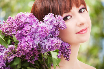 Poster - Young woman with lilac flowers