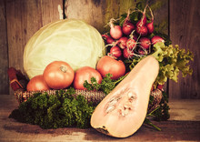 Fruits And Vegetables On A Basket With A Rustic Background