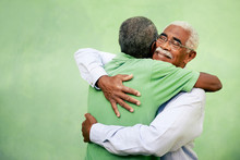 Old Friends, Two Senior African American Men Meeting And Hugging