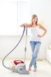 © Anton Maltsev - Attractive girl with vacuum cleaner