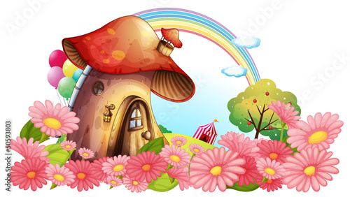 Obraz w ramie A mushroom house with a garden of flowers