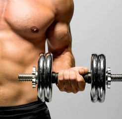 powerful muscular man lifting weights