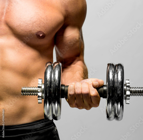 Fototapeta na wymiar powerful muscular man lifting weights