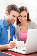 Wall Mural - Couple looking at laptop