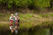 © Maygutyak - Little girls are fishing on lake in forest