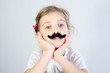 © Pavel Losevsky - Little melancholy girl in white with glued fake black mustache.