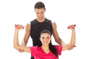 Woman with her personal fitness trainer exercising with weights