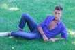 © Viorel Sima - serious young man resting in grass