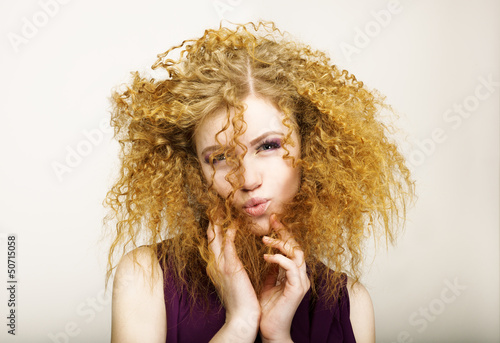 Fotografie, Obraz Embarrassment. Shaggy Red-Haired Curly woman grimacing