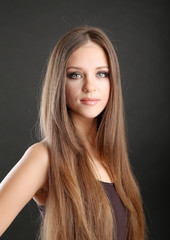 Poster - Portrait of beautiful woman with long hair on black background