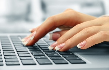 Wall Mural - Female hands typing on laptot, close-up