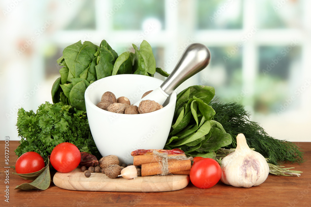 Composition of mortar, spices, tomatoes and  green herbs,