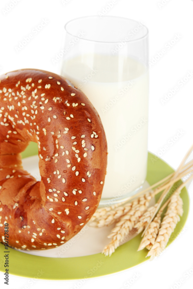 Bread roll and glass of milk isolated on white