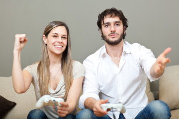 Wall Mural - Couple playing video games at home