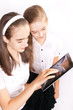 © Natalya Antoshchenko - Two Girl with ipad like gadget