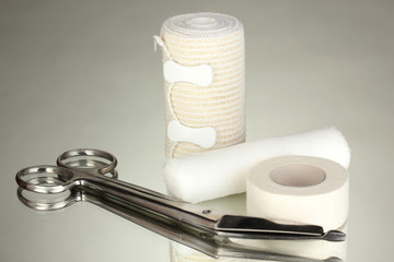 First aid kit for bandaging on grey background