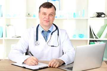 Canvas Print - Medical doctor working at desk