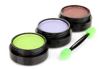 Bright eye shadows and sponge brushes for foundation isolated