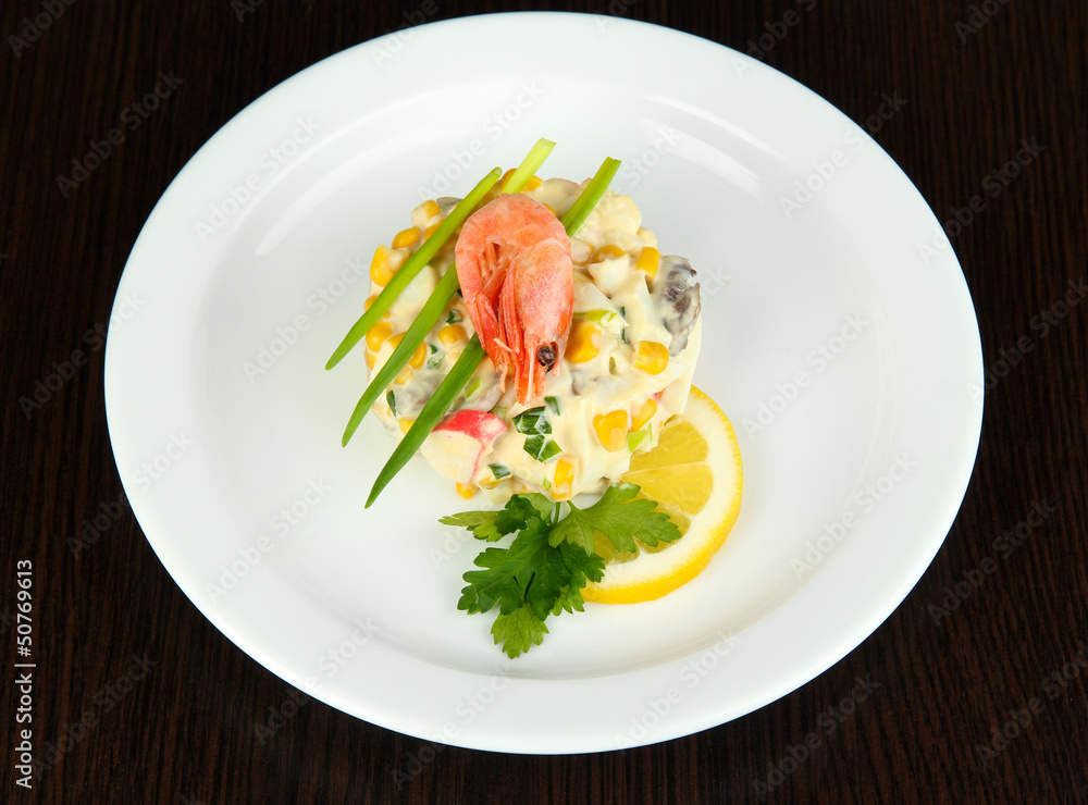 Small portion of food on big plate on wooden table