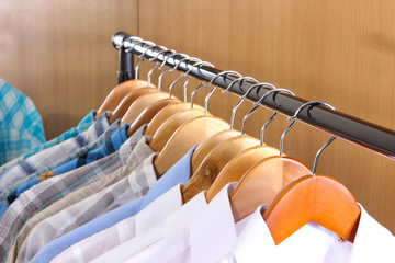 Wall Mural - Men's shirts on hangers in wardrobe