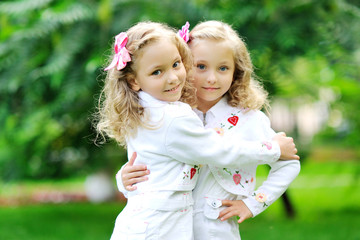 Wall Mural - portrait of two sisters twins in the summer