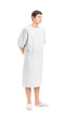 Full length portrait of a male patient in a hospital gown lookin