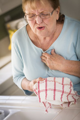 Wall Mural - Senior Adult Woman At Sink With Chest Pains