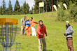 © CandyBox Images - Couple throwing frisbee disc at springtime park